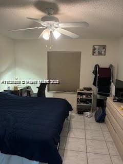 1001 Green Pine Blvd Unit H2, West Palm Beach, FL 33409 - bedroom featuring light tile patterned floors, a ceiling fan, and a textured ceiling