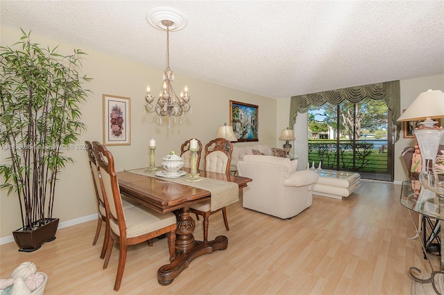 901 Colony Point Cir Unit 107, Pembroke Pines, FL 33026 - dining room featuring a chandelier, wood finished floors, and a textured ceiling