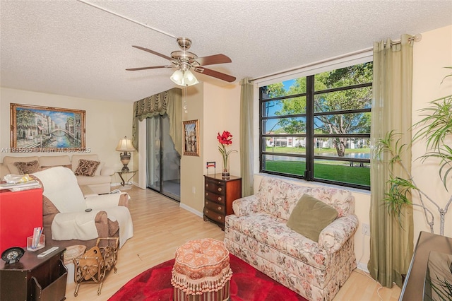 901 Colony Point Cir Unit 107, Pembroke Pines, FL 33026 - living room with wood finished floors, a textured ceiling, a ceiling fan, and a water view