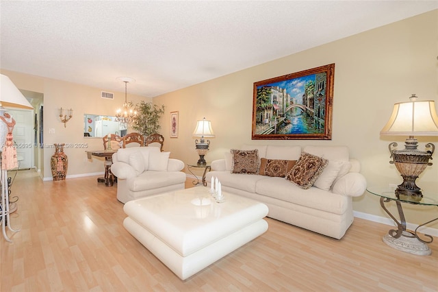 901 Colony Point Cir Unit 107, Pembroke Pines, FL 33026 - living room with light wood finished floors, a chandelier, and a textured ceiling