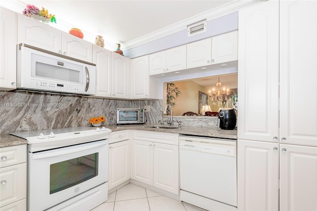 901 Colony Point Cir Unit 107, Pembroke Pines, FL 33026 - kitchen featuring white appliances, a chandelier, light tile patterned floors, light stone counters, and crown molding