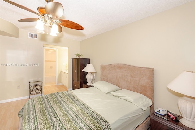 901 Colony Point Cir Unit 107, Pembroke Pines, FL 33026 - bedroom with wood finished floors, a ceiling fan, and ensuite bath
