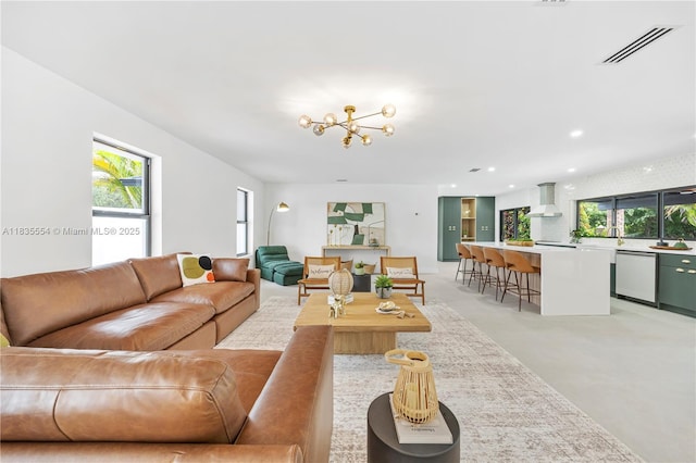 12505 SW 99th Ave, Miami, FL 33176 - living area featuring recessed lighting, finished concrete floors, and a chandelier