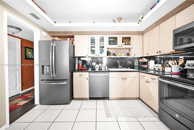 9341 E Bay Harbor Dr Unit 3D, Bay Harbor Islands, FL 33154 - kitchen with stainless steel appliances, backsplash, dark countertops, and a tray ceiling