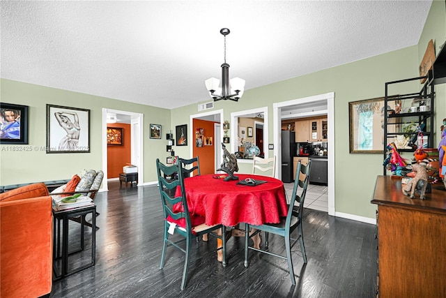 9341 E Bay Harbor Dr Unit 3D, Bay Harbor Islands, FL 33154 - dining room featuring a chandelier, dark wood-style flooring, and a textured ceiling
