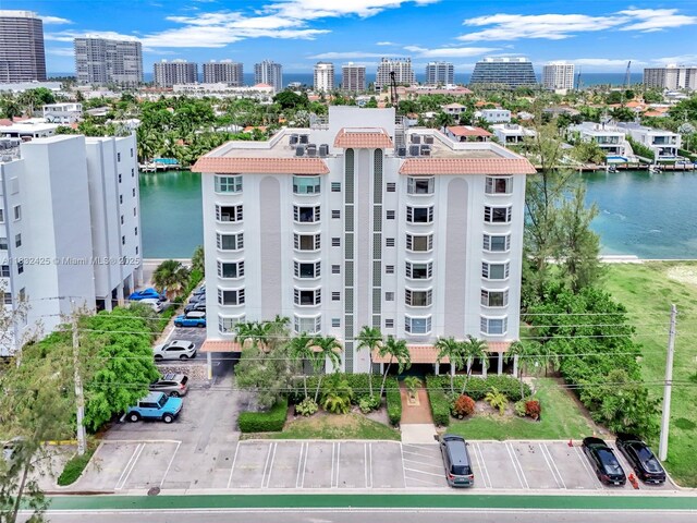 9341 E Bay Harbor Dr Unit 3D, Bay Harbor Islands, FL 33154 - view of building exterior with a water view, uncovered parking, and a view of city