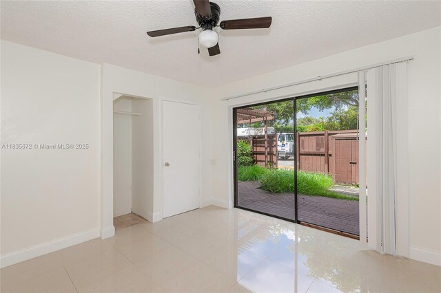6455SW SW 116th Pl Unit C, Miami, FL 33173 - unfurnished room with a textured ceiling, a ceiling fan, and light tile patterned floors