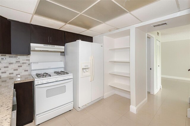 6455SW SW 116th Pl Unit C, Miami, FL 33173 - kitchen featuring under cabinet range hood, white appliances, a paneled ceiling, decorative backsplash, and light tile patterned floors