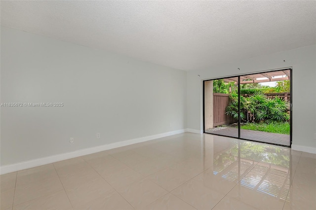 6455SW SW 116th Pl Unit C, Miami, FL 33173 - spare room featuring a textured ceiling and light tile patterned flooring