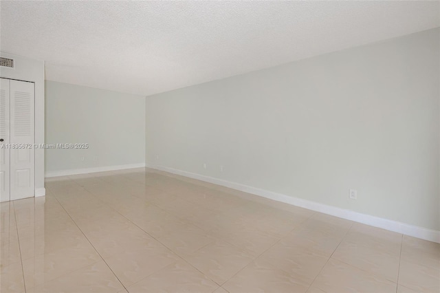 6455SW SW 116th Pl Unit C, Miami, FL 33173 - spare room featuring a textured ceiling and light tile patterned floors
