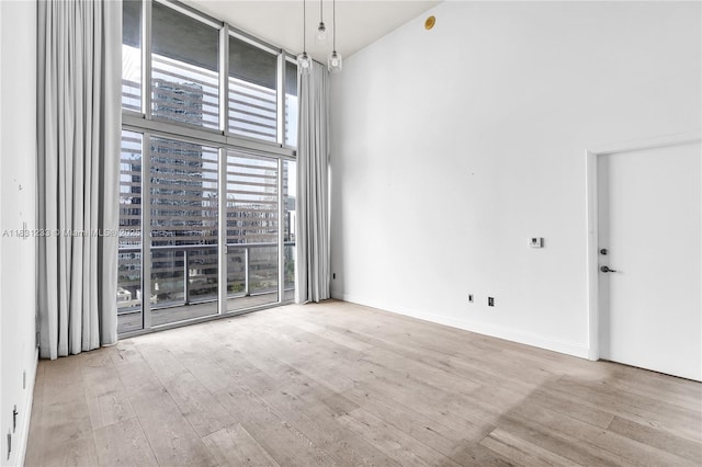495 SE Brickell Ave Unit 1511, Miami, FL 33131 - empty room with wood finished floors and a wall of windows