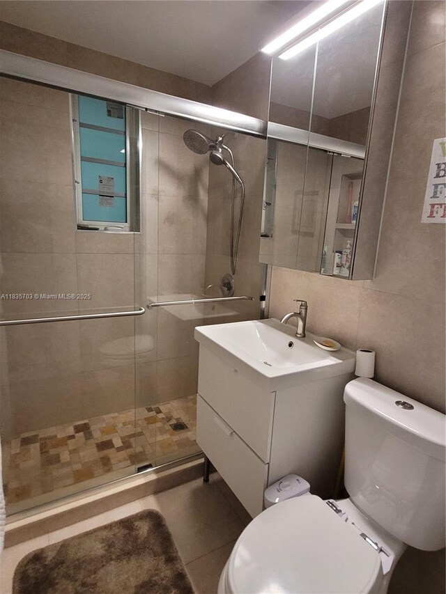 349 Meridian Ave Unit B103, Miami Beach, FL 33139 - bathroom featuring vanity, a shower stall, and tile walls