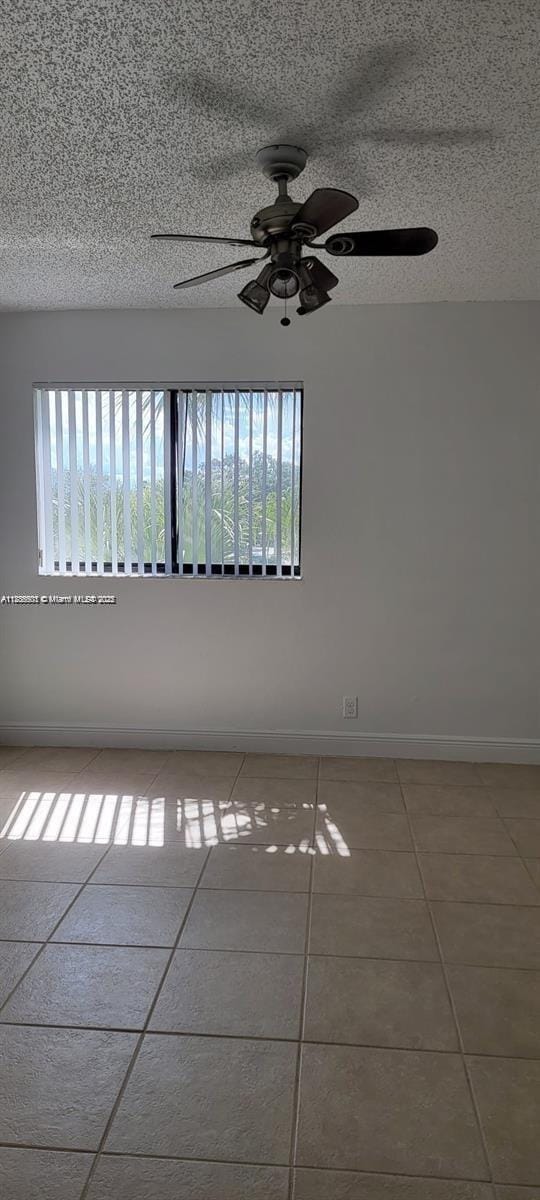 2846 S University Dr Unit 4308, Davie, FL 33328 - spare room featuring tile patterned floors, ceiling fan, and a textured ceiling