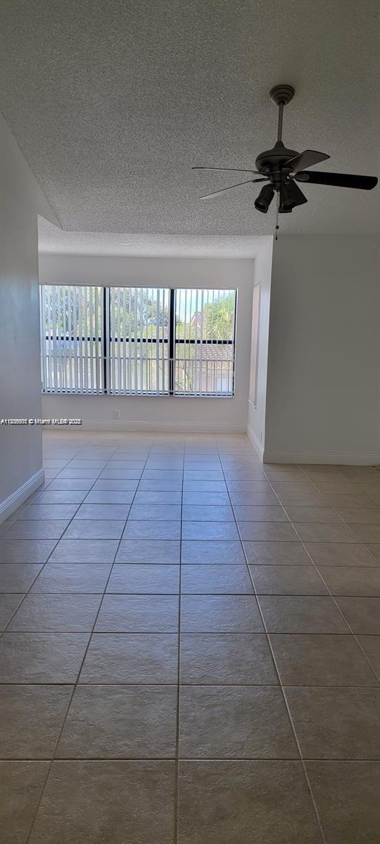 2846 S University Dr Unit 4308, Davie, FL 33328 - tiled spare room with a textured ceiling and a ceiling fan