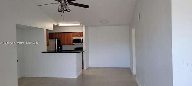 2846 S University Dr Unit 4308, Davie, FL 33328 - kitchen with appliances with stainless steel finishes, ceiling fan, dark countertops, brown cabinets, and a peninsula
