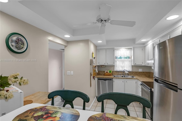 2420 Deer Creek Country Club Blvd Unit 203-D, Deerfield Beach, FL 33442 - kitchen with appliances with stainless steel finishes, recessed lighting, white cabinets, ceiling fan, and light tile patterned floors