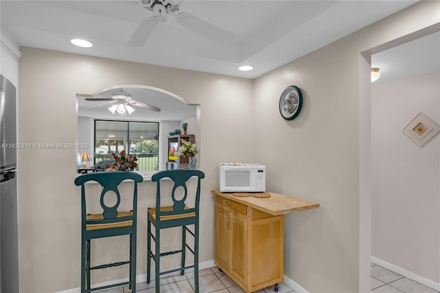 2420 Deer Creek Country Club Blvd Unit 203-D, Deerfield Beach, FL 33442 - bar featuring ceiling fan, white microwave, arched walkways, recessed lighting, and light tile patterned flooring