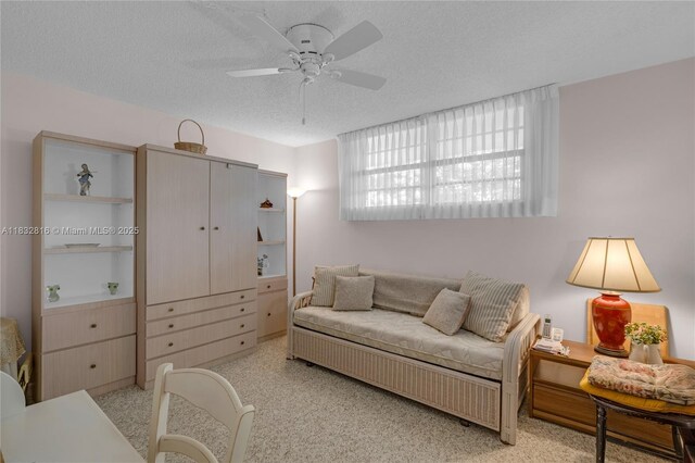 2420 Deer Creek Country Club Blvd Unit 203-D, Deerfield Beach, FL 33442 - living area featuring ceiling fan, a textured ceiling, and light carpet