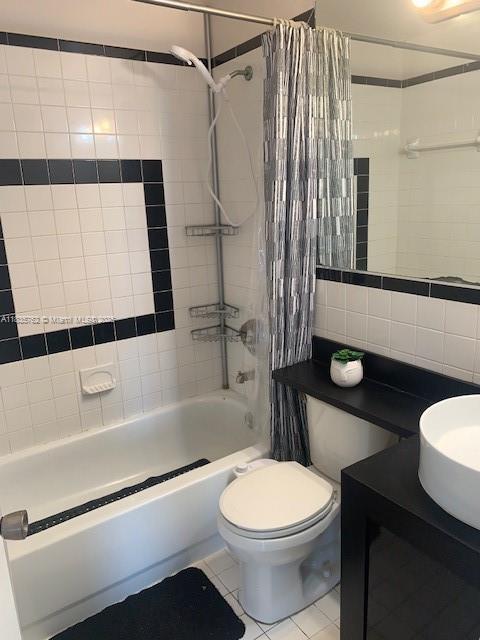 1244 Pennsylvania Ave Unit 306, Miami Beach, FL 33139 - bathroom featuring shower / bath combo, tile patterned floors, vanity, and tile walls