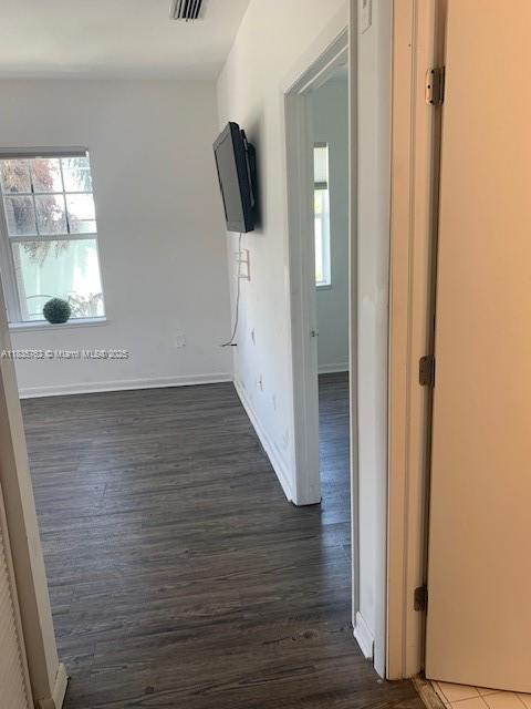 1244 Pennsylvania Ave Unit 306, Miami Beach, FL 33139 - unfurnished room with dark wood-style flooring and baseboards