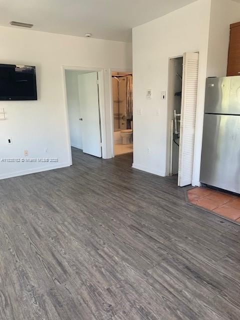 1244 Pennsylvania Ave Unit 306, Miami Beach, FL 33139 - unfurnished living room with dark wood-type flooring and baseboards