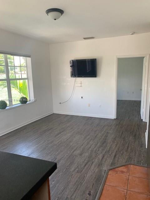 1244 Pennsylvania Ave Unit 306, Miami Beach, FL 33139 - unfurnished living room featuring dark wood finished floors
