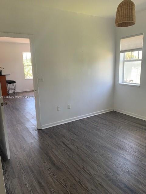 1244 Pennsylvania Ave Unit 306, Miami Beach, FL 33139 - unfurnished room with dark wood-style flooring and plenty of natural light