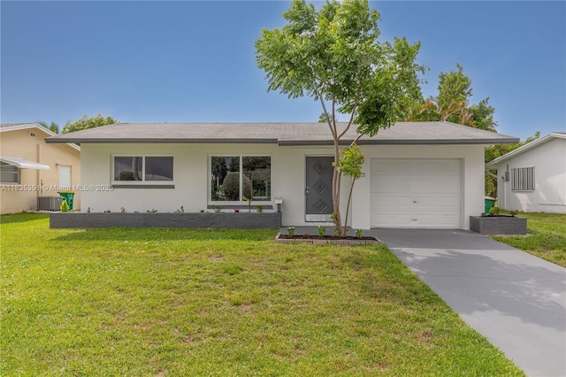 4516 Mainland Dr, Tamarac, FL 33319 - ranch-style home with stucco siding, an attached garage, driveway, and a front lawn