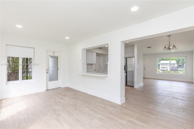 4516 Mainland Dr, Tamarac, FL 33319 - unfurnished living room featuring a chandelier, light wood-style floors, and recessed lighting