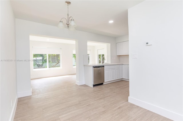 4516 Mainland Dr, Tamarac, FL 33319 - kitchen with dishwasher, a chandelier, light countertops, white cabinetry, and hanging light fixtures