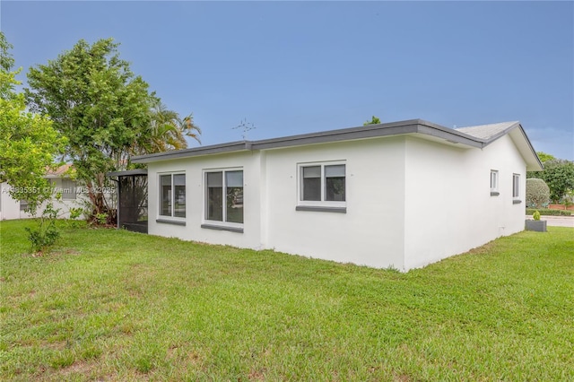 4516 Mainland Dr, Tamarac, FL 33319 - rear view of property featuring stucco siding, a lawn, and a sunroom
