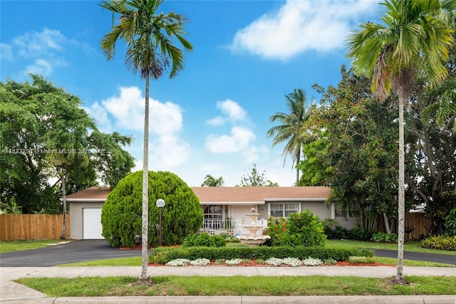 4235 SW 97th Ave, Miami, FL 33165 - view of front of property featuring a garage, asphalt driveway, and stucco siding