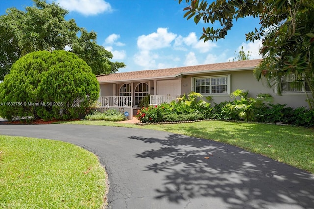 4235 SW 97th Ave, Miami, FL 33165 - ranch-style house with stucco siding, covered porch, and a front yard