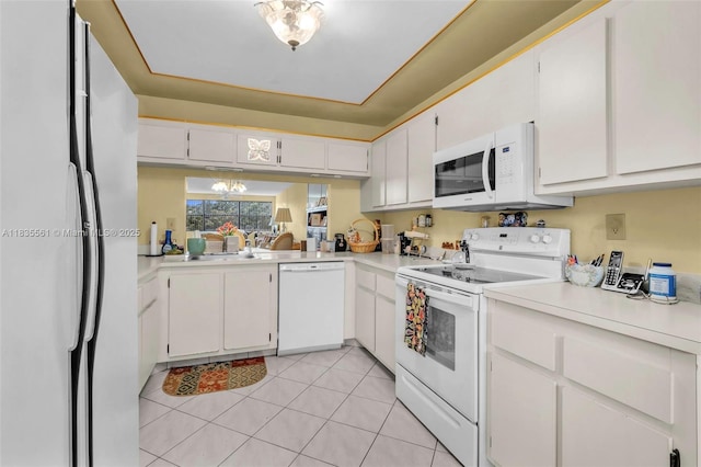 10400 NW 30th Ct Unit 305, Sunrise, FL 33322 - kitchen with white appliances, light countertops, white cabinets, light tile patterned floors, and a chandelier