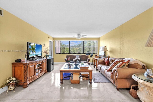 10400 NW 30th Ct Unit 305, Sunrise, FL 33322 - living room featuring a ceiling fan and a textured wall