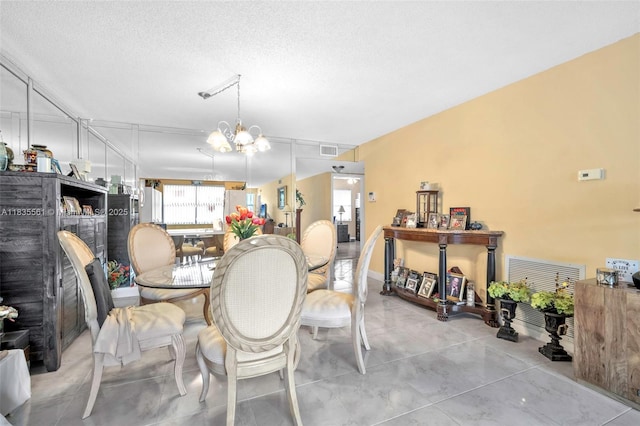 10400 NW 30th Ct Unit 305, Sunrise, FL 33322 - dining area featuring a chandelier and a textured ceiling