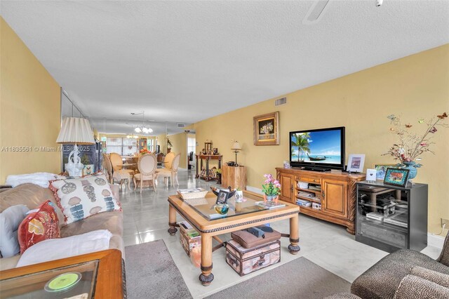 10400 NW 30th Ct Unit 305, Sunrise, FL 33322 - living area with a chandelier and a textured ceiling