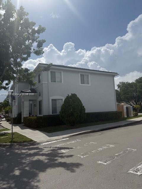 7325NW 174th Te # 104, Miami Lakes, FL 33015 - view of side of property with stucco siding