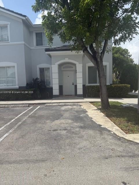 7325NW 174th Te # 104, Miami Lakes, FL 33015 - view of front of home featuring uncovered parking and stucco siding