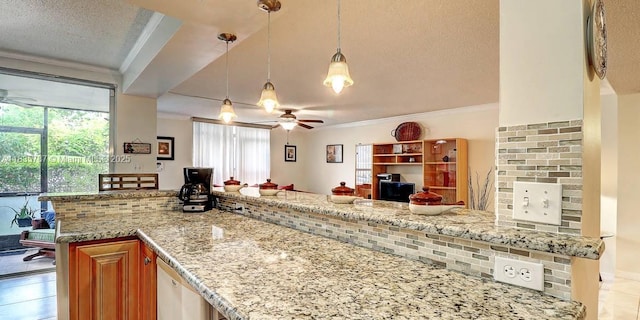 3750 Inverrary Dr Unit 1Z, Lauderhill, FL 33319 - kitchen with crown molding, a ceiling fan, a textured ceiling, open floor plan, and light stone countertops
