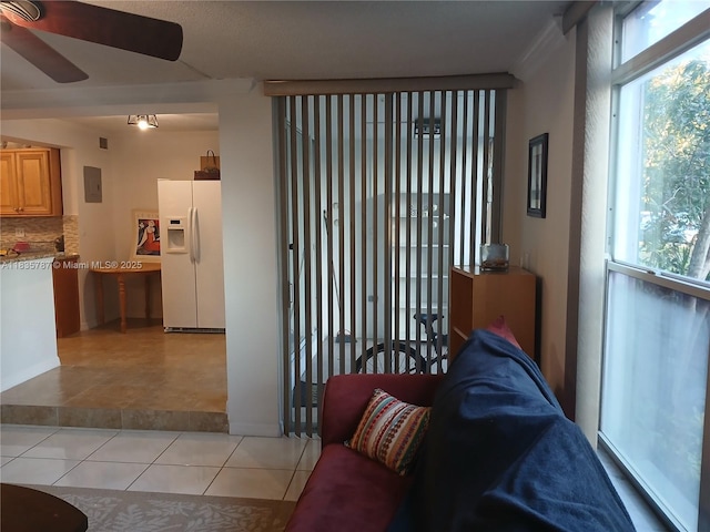 3750 Inverrary Dr Unit 1Z, Lauderhill, FL 33319 - living area with healthy amount of natural light, a ceiling fan, and light tile patterned flooring