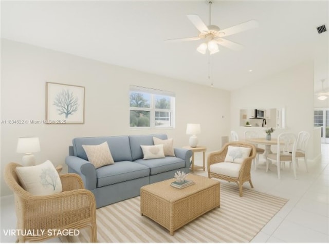653 NW San Remo Cir, Port St Lucie, FL 34986 - tiled living room with a ceiling fan and high vaulted ceiling
