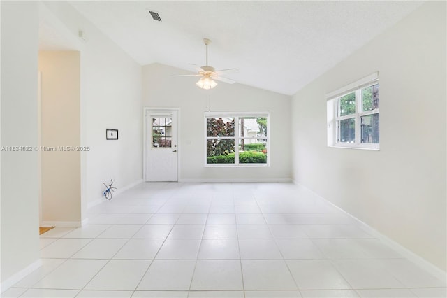 653 NW San Remo Cir, Port St Lucie, FL 34986 - spare room featuring a ceiling fan, vaulted ceiling, and light tile patterned flooring