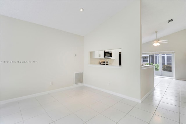 653 NW San Remo Cir, Port St Lucie, FL 34986 - spare room featuring high vaulted ceiling, ceiling fan, and light tile patterned floors