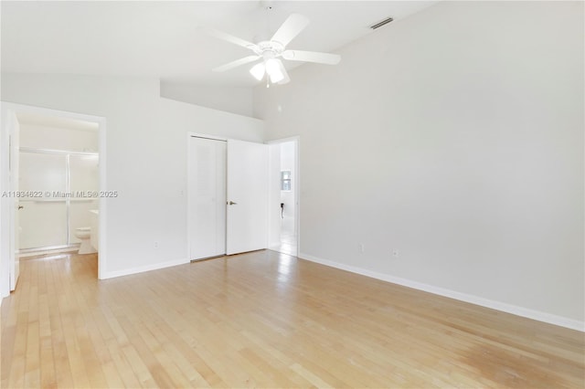 653 NW San Remo Cir, Port St Lucie, FL 34986 - spare room featuring light wood finished floors, ceiling fan, and high vaulted ceiling