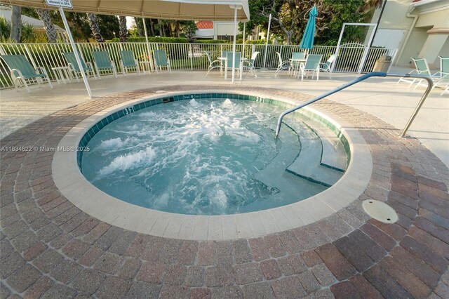 653 NW San Remo Cir, Port St Lucie, FL 34986 - view of swimming pool featuring a swimming pool, a patio area, and a hot tub