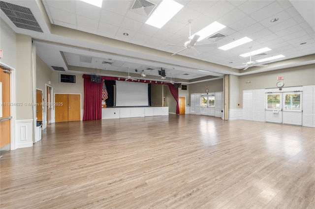 653 NW San Remo Cir, Port St Lucie, FL 34986 - unfurnished room featuring a ceiling fan, light wood-style flooring, a drop ceiling, a skylight, and wainscoting