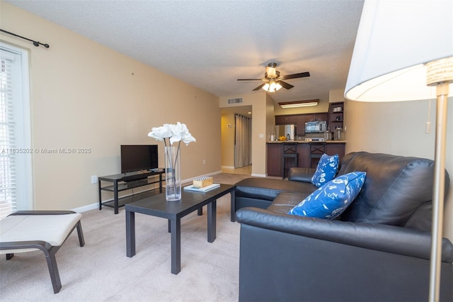 1280 S Alhambra Cir Unit 1310, Coral Gables, FL 33146 - living area featuring light carpet, ceiling fan, and a textured ceiling