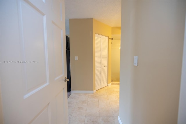 1280 S Alhambra Cir Unit 1310, Coral Gables, FL 33146 - hallway with a textured ceiling and light tile patterned floors