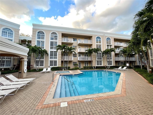 1280 S Alhambra Cir Unit 1310, Coral Gables, FL 33146 - community pool featuring a patio and a hot tub